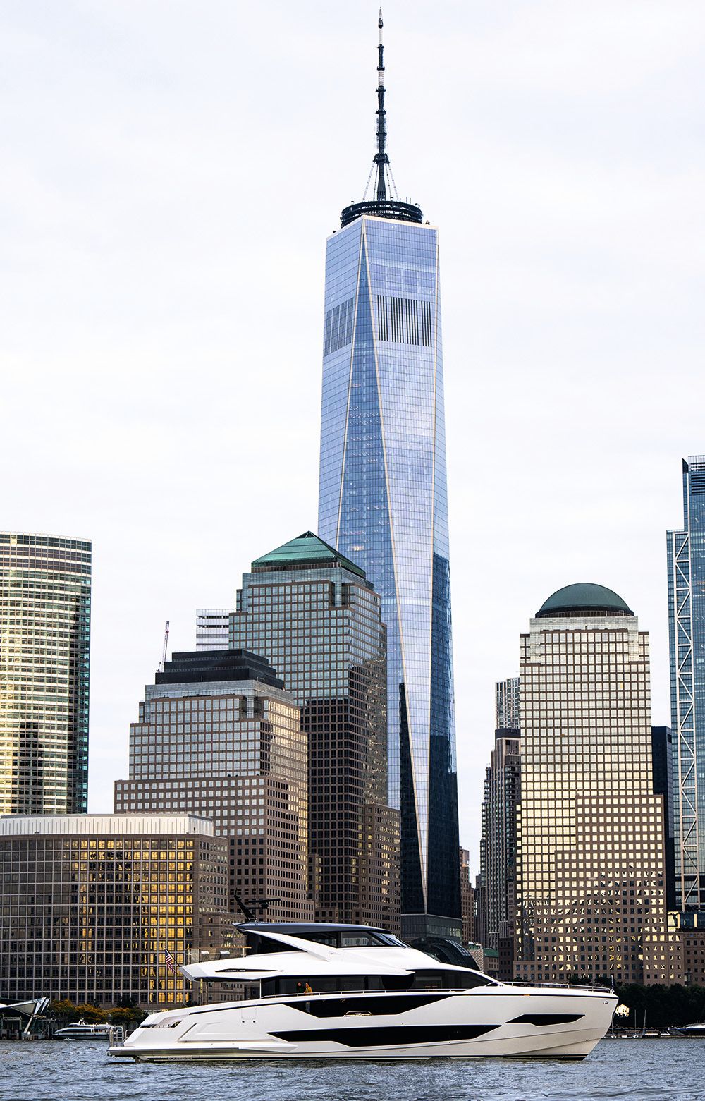 Wide shot of Ocean 182 on the water with city skyscraper backdrop
