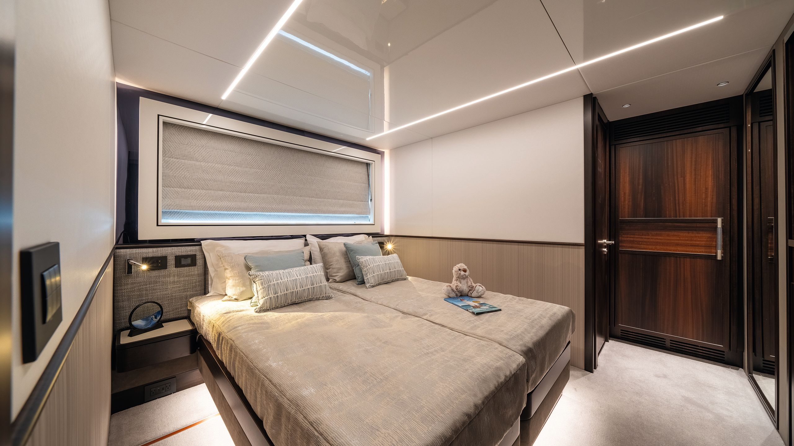 Guest cabin in double bed formation with neutral linens