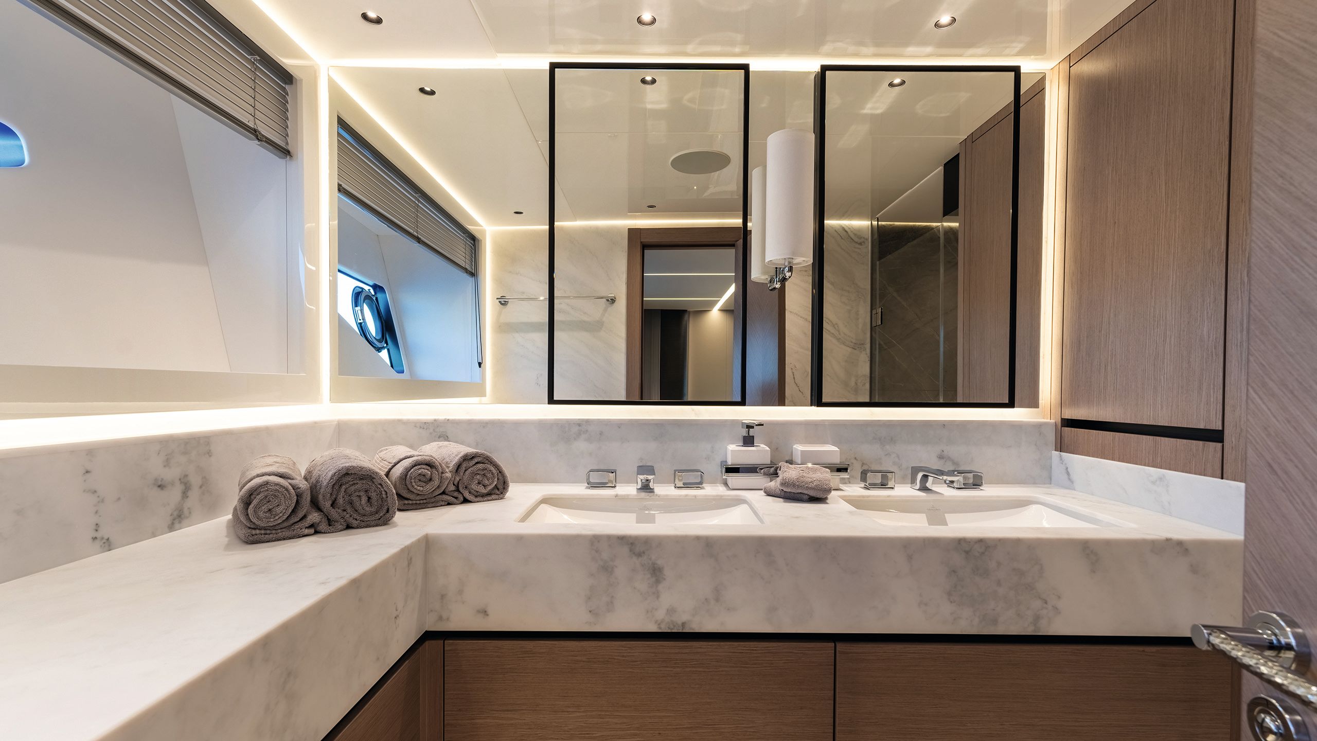 Bathroom with double sinks and mirrors with marble counters