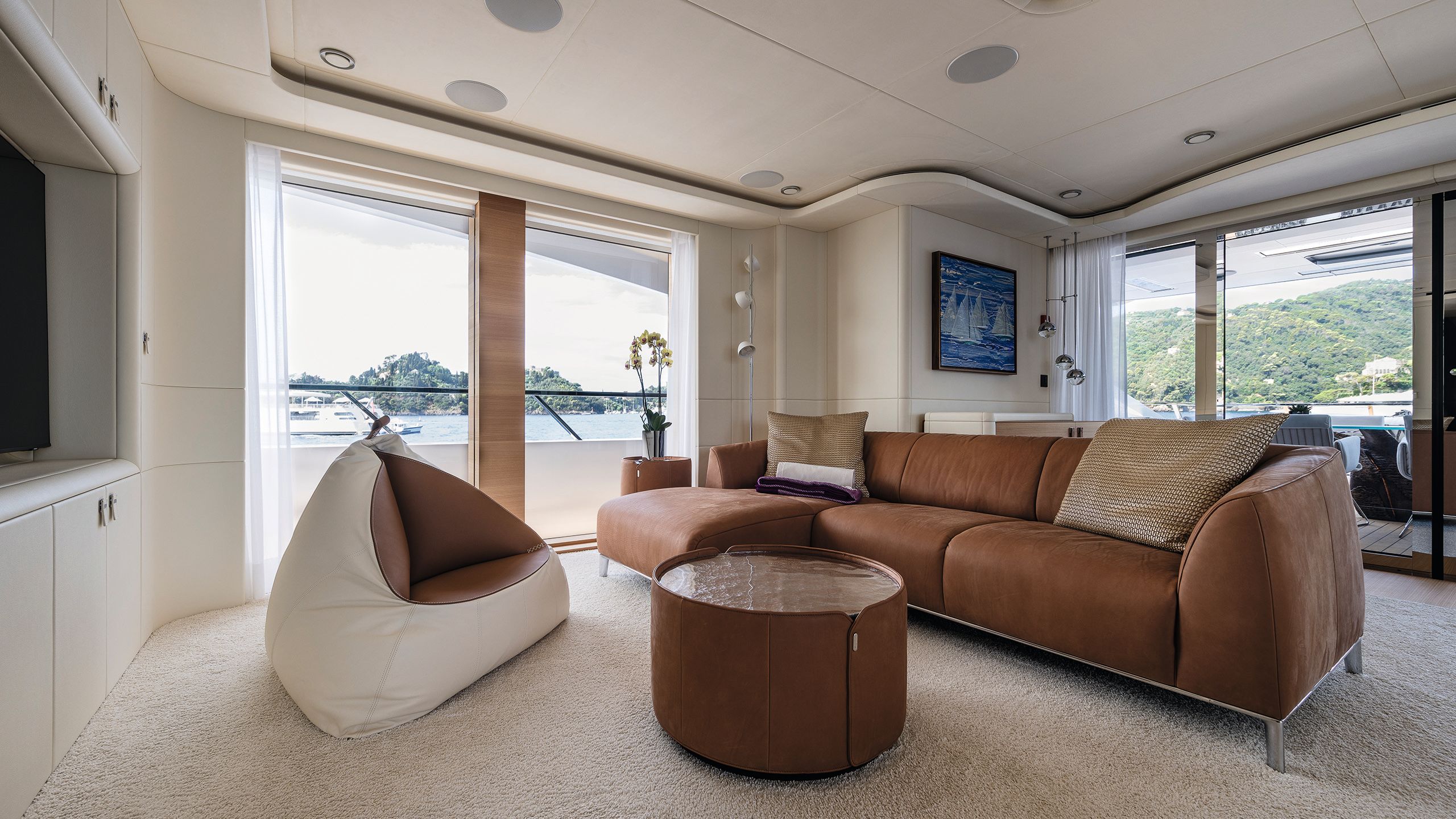 Lounge area with brown leather L-shape sofa