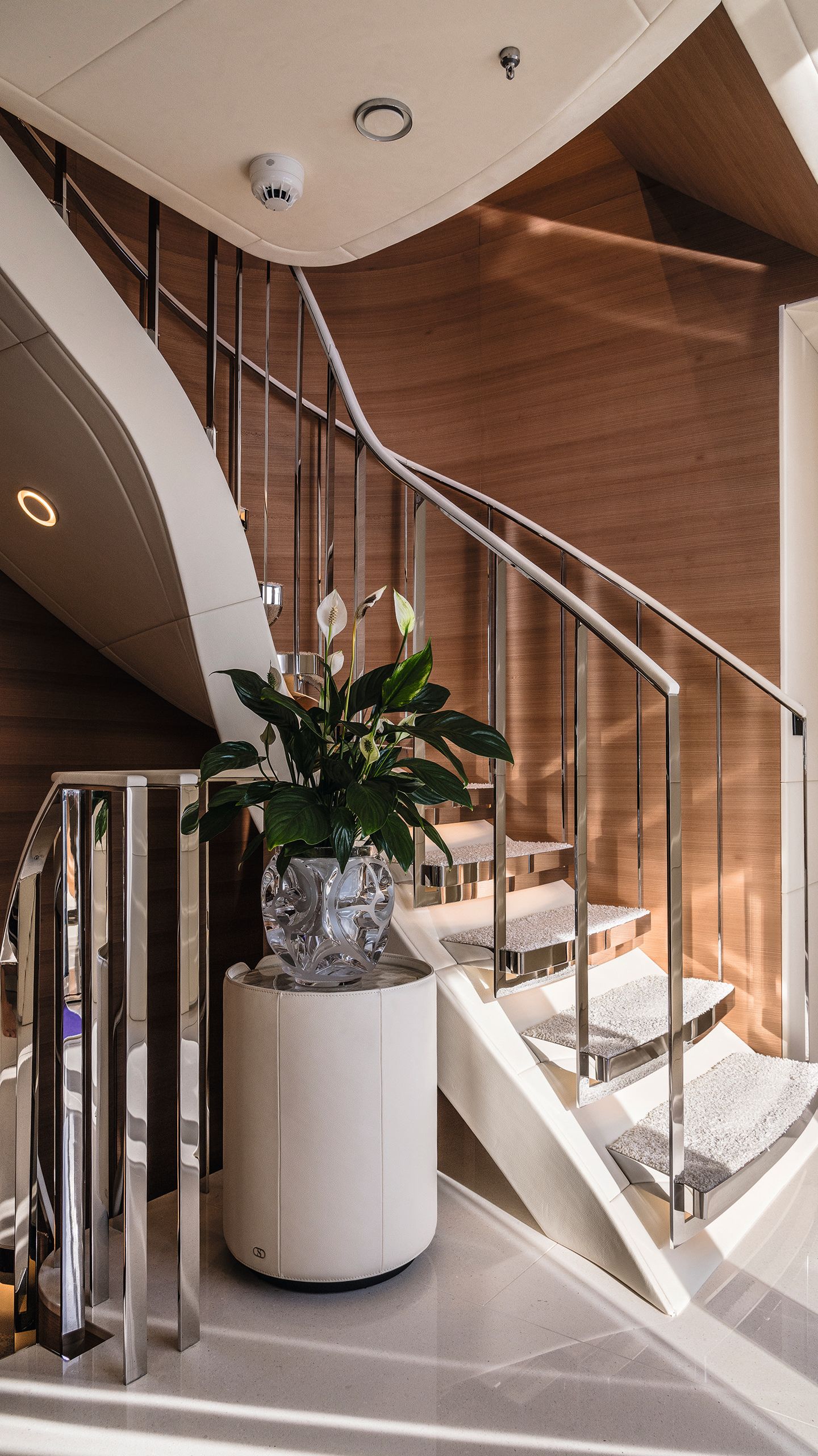Staircase with vase of flowers in foreground