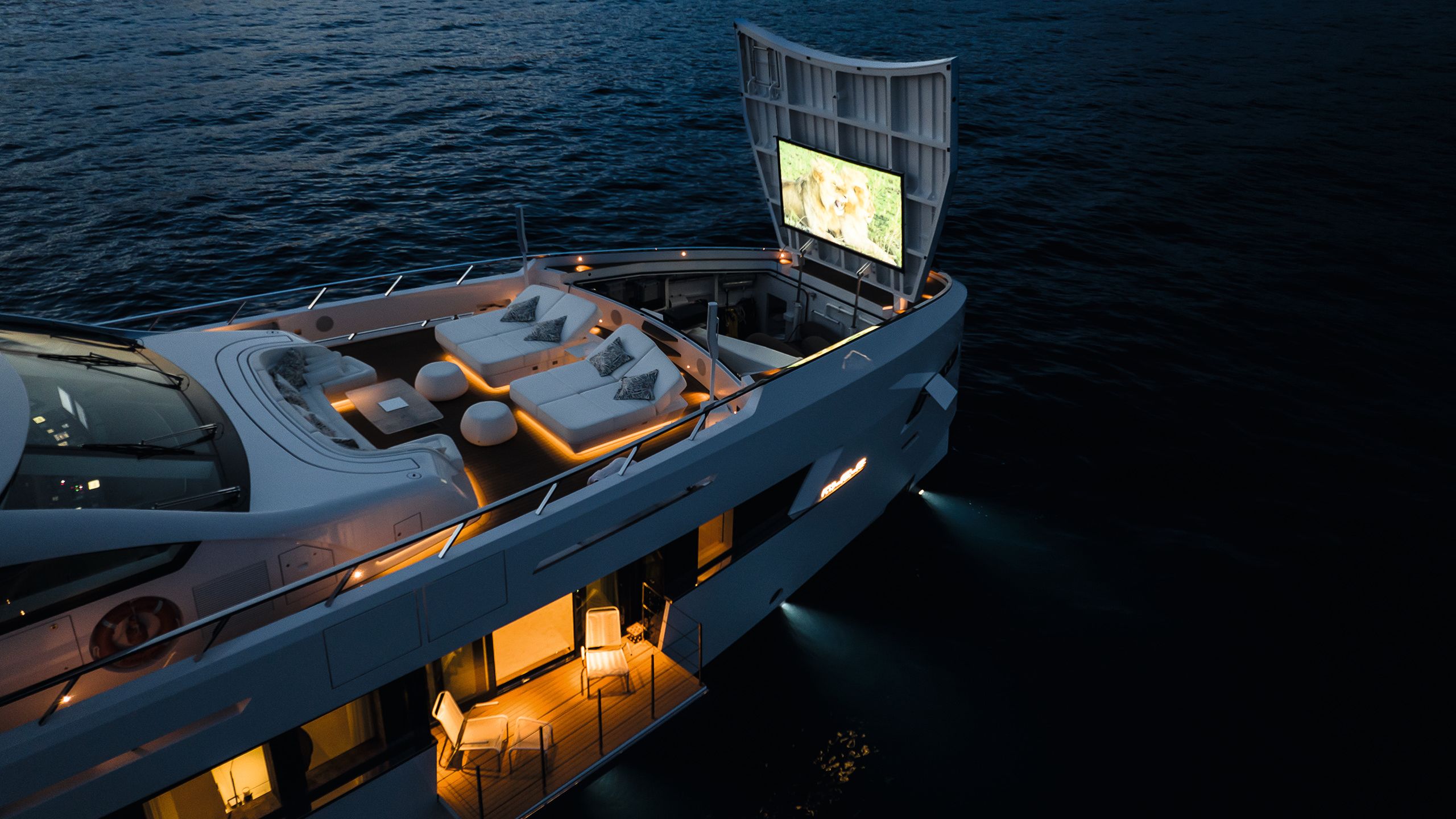 Forward hatch lifted up to show cinema screen at night