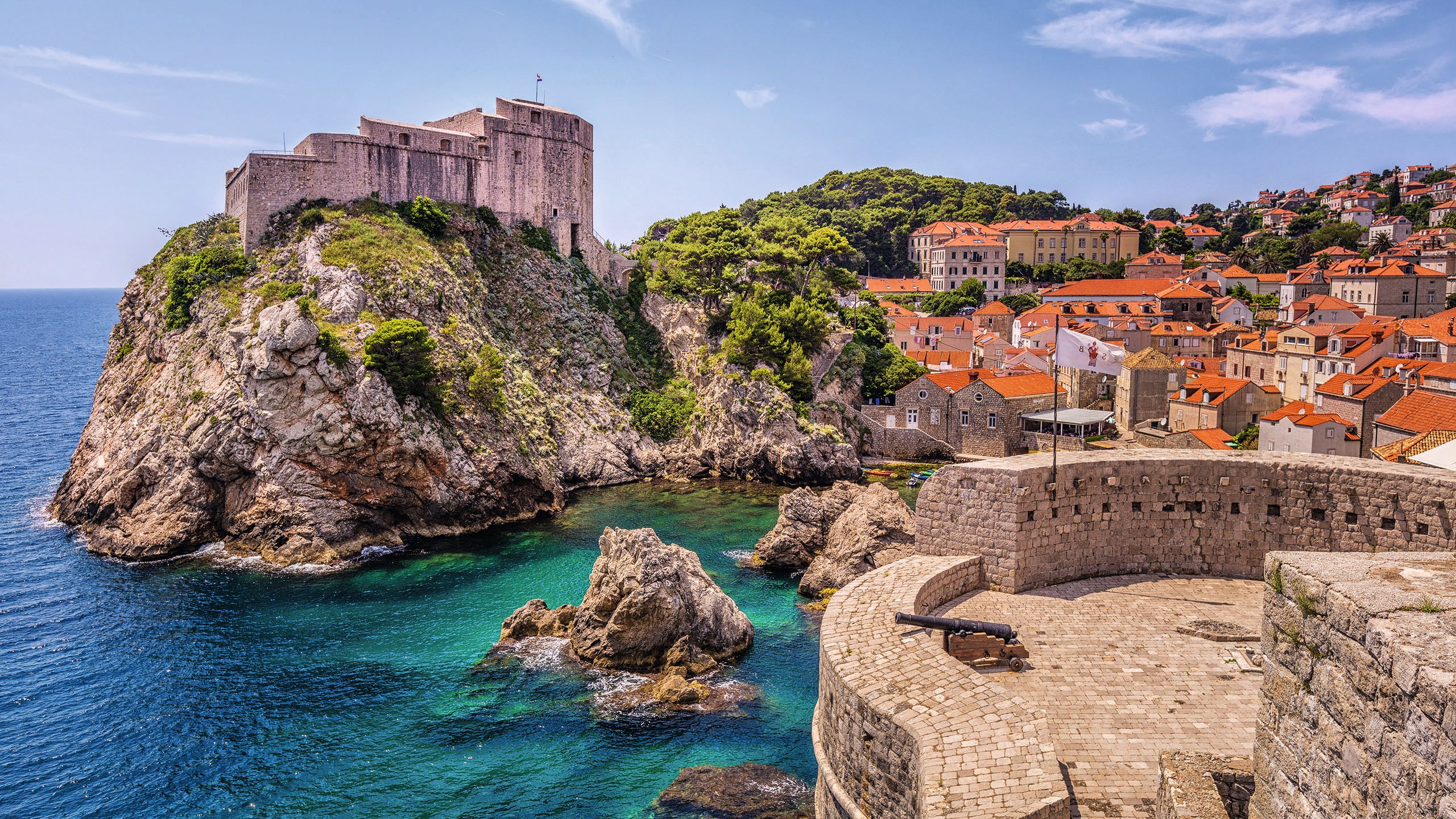 Looking towards a landmark on a hill in Dubrovnik. The buildings around all have red roofs