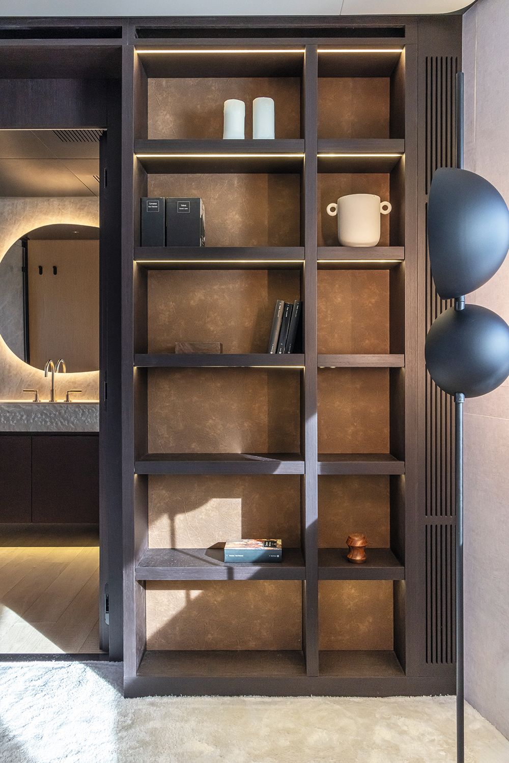 Brown bookshelf with vase and books