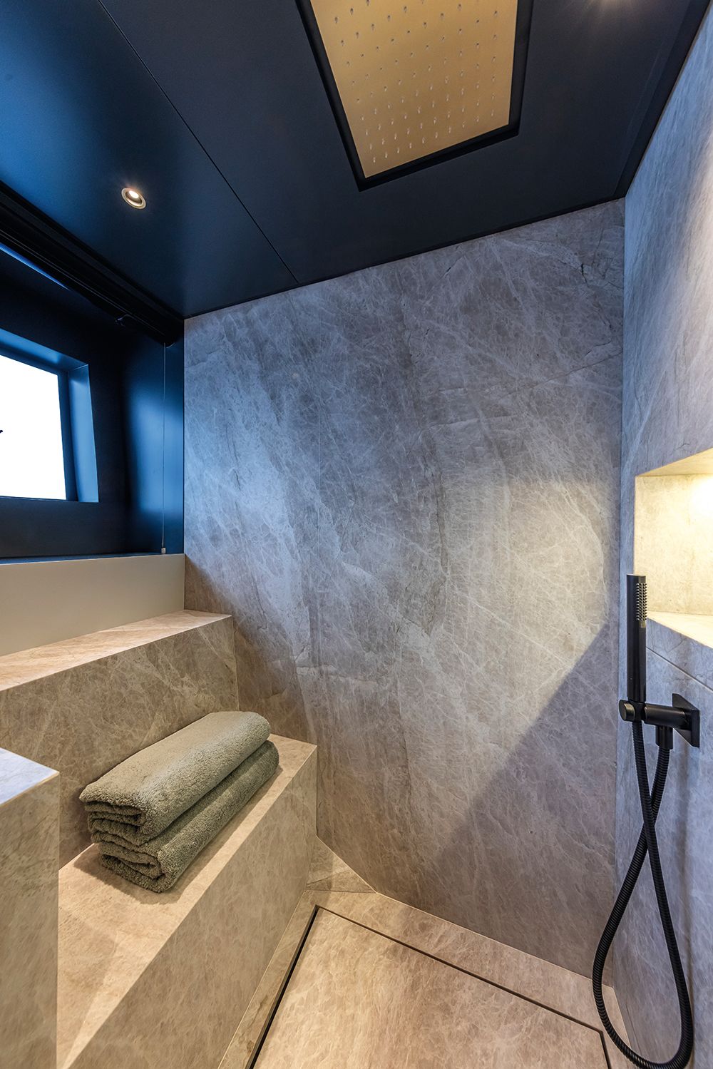 Walk-in shower with towels and fittings