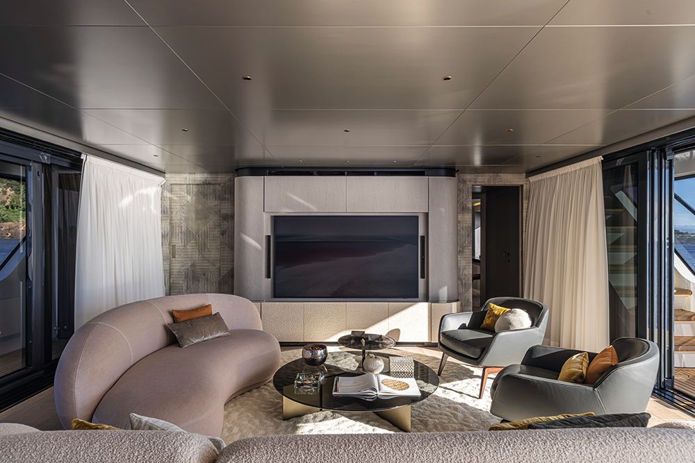 Leather chairs, curved sofa and TV