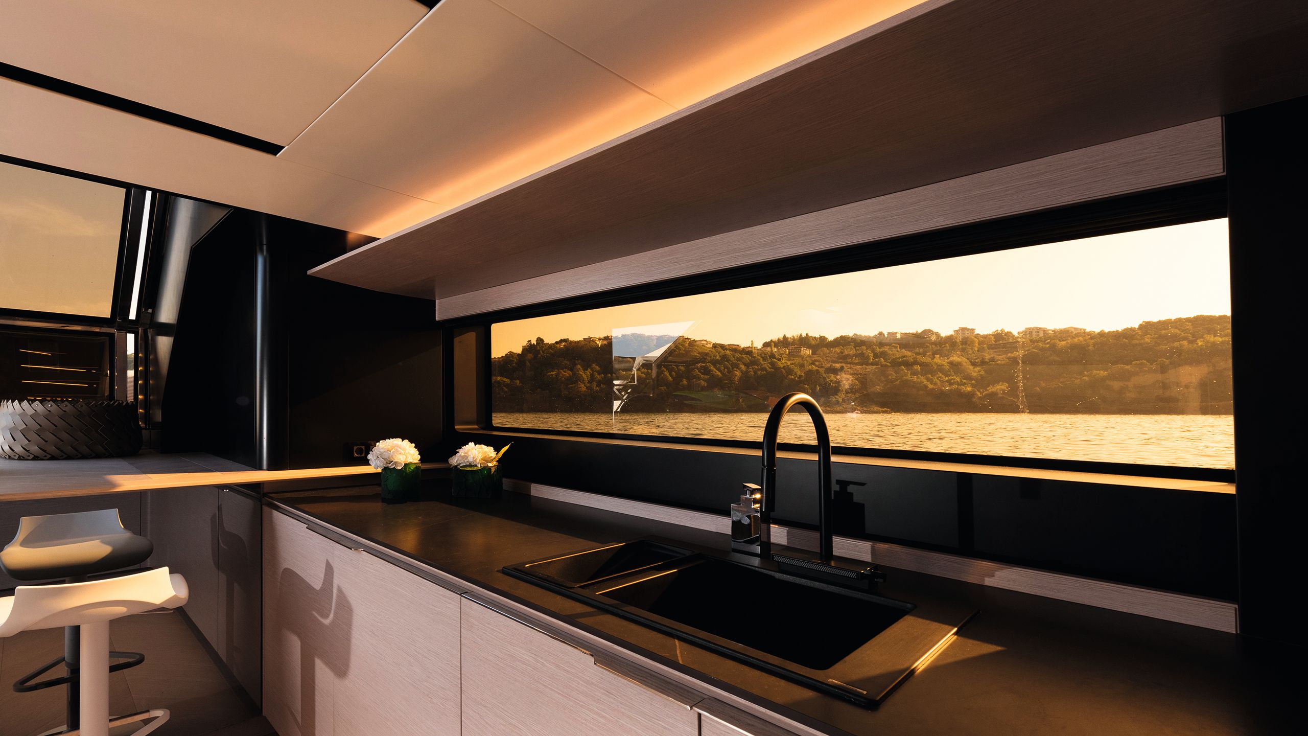 Kitchen area of the saloon done in black with long wide window