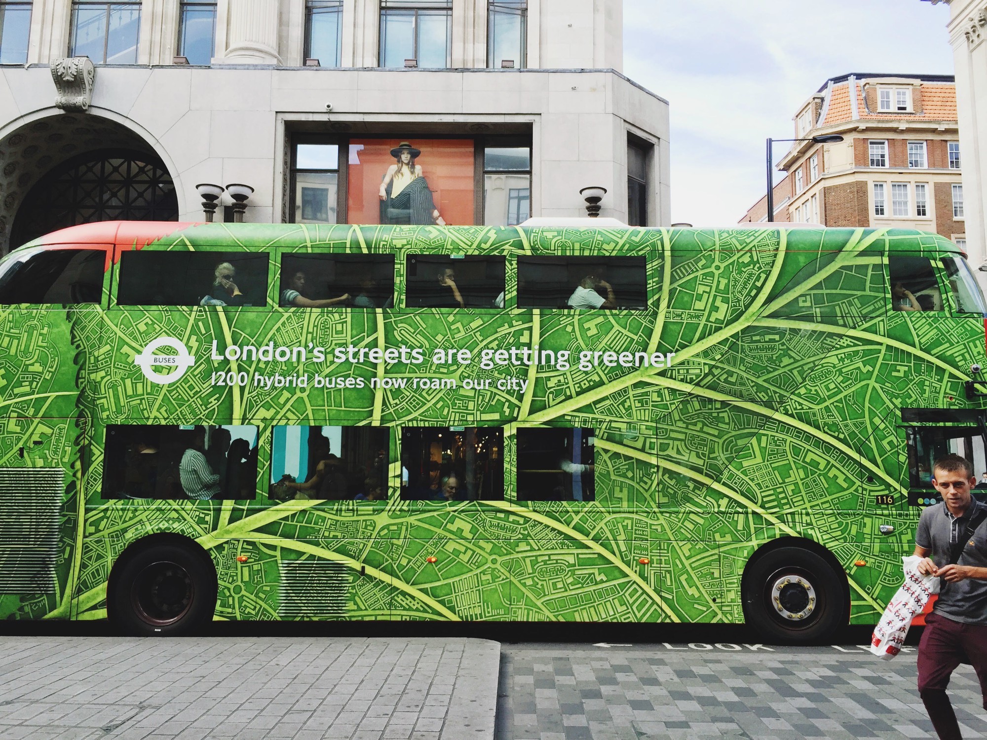 A green two story bus in London