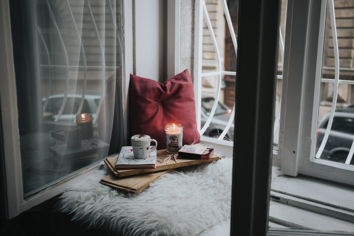 Hygge evening with candles and a cup of cacao