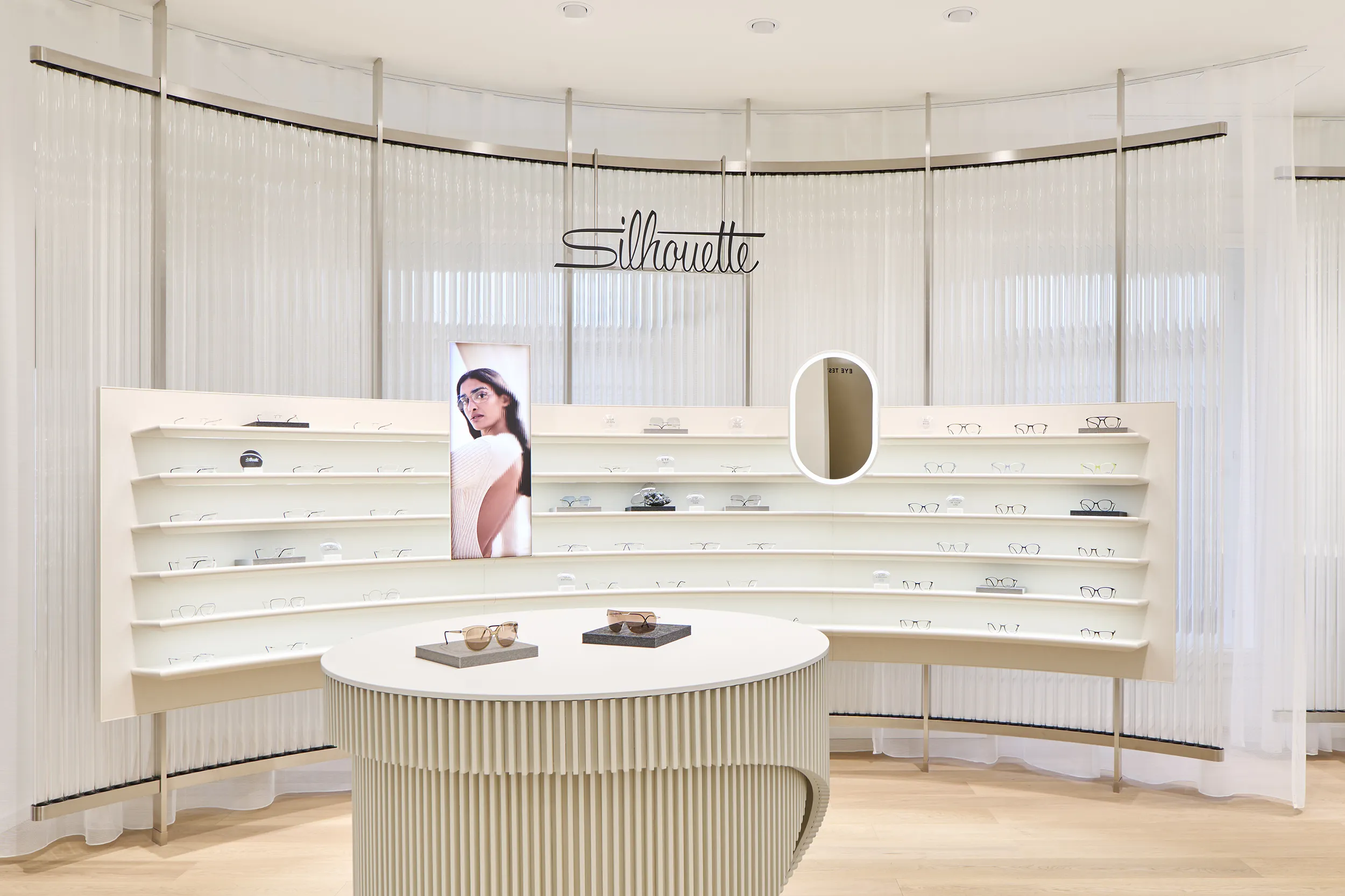 Premium eyewear displayed within an acoustically optimized retail environment.