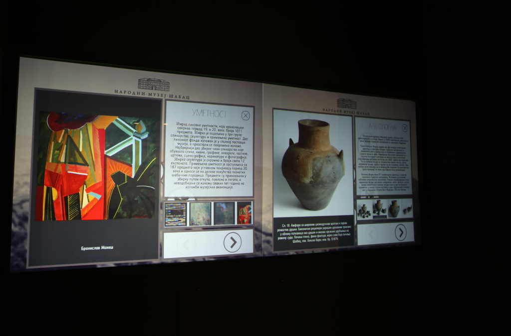 An interactive exhibit with dual screens providing detailed information about historical items and artwork.