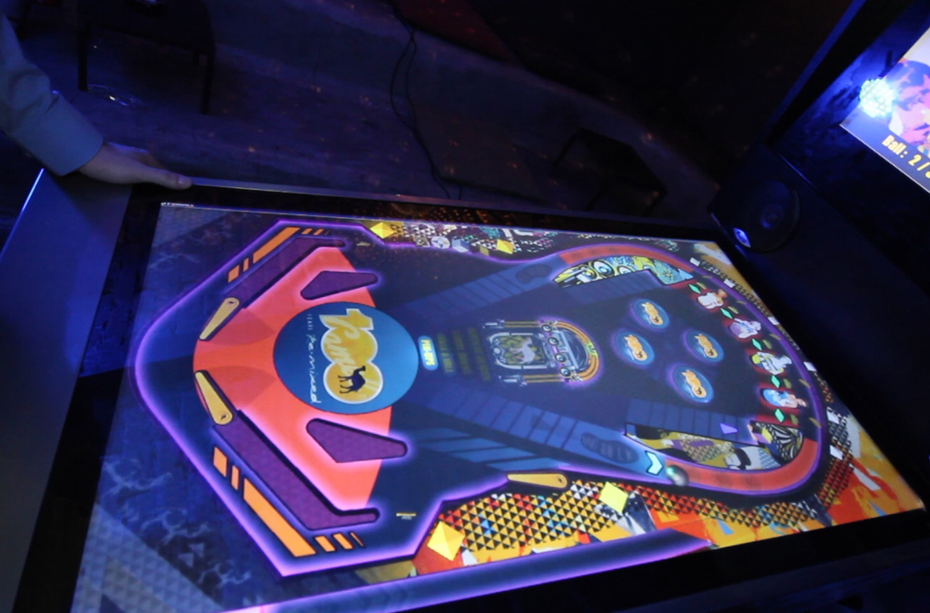 Close-up of a digital pinball screen with Camel branding, displaying colorful graphics and game elements.