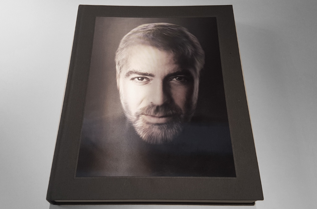 The cover of 'Money People Politics' featuring a portrait of George Clooney, with a thoughtful expression and subtle lighting that highlights his features.