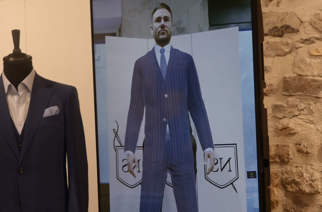 A Virtual Mirror display shows a man virtually wearing a tailored suit.
