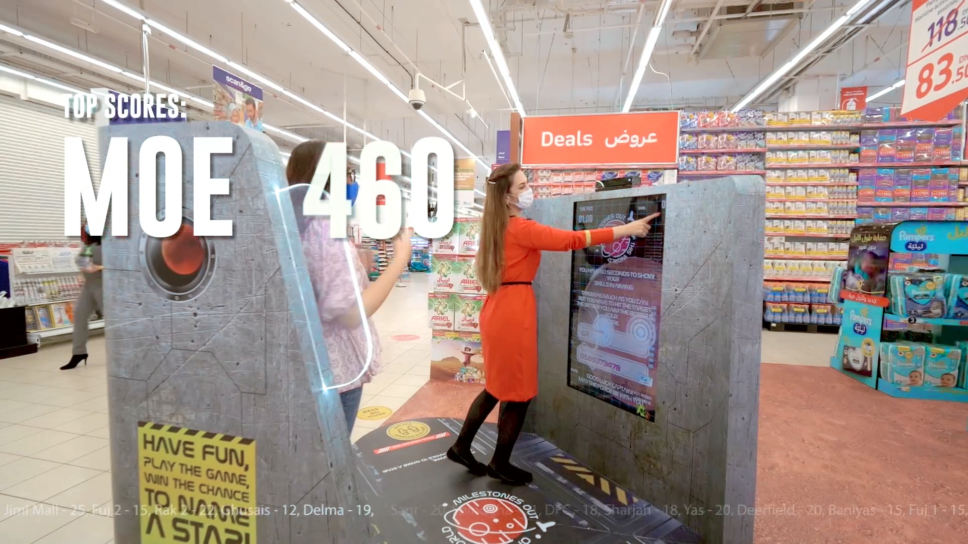 Interactive gaming kiosk in a supermarket setting, featuring the "MARS Landing Kinect Game" by Digital Mind.he kiosk showcases an on-screen display with Procter & Gamble (P&G) branding and a countdown timer, promoting engagement by combining retail with the celebration of the UAE's first Mars mission.