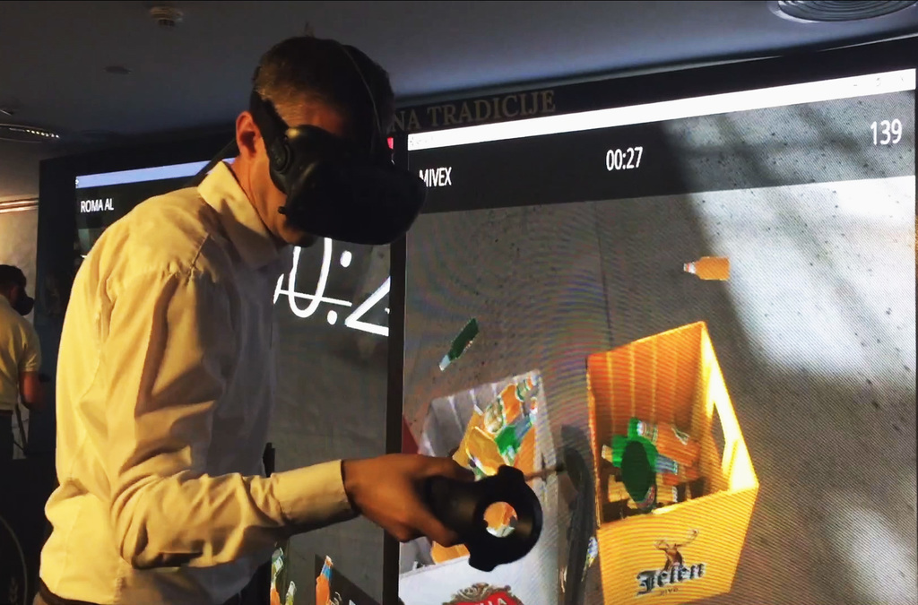 A player wearing an HTC VIVE VR headset and holding a controller, engaged in a virtual bottle sorting game, with a digital scoreboard in the background.