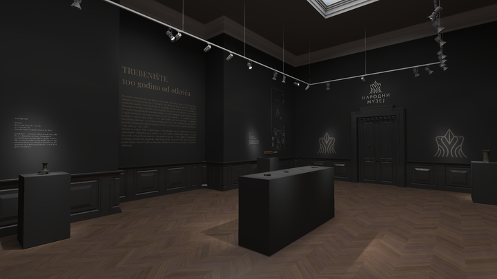 Wide-angle view of a dimly lit museum room with black walls and wood flooring, featuring text panels and a variety of small lit displays against the walls, with a skylight providing natural light from above.
