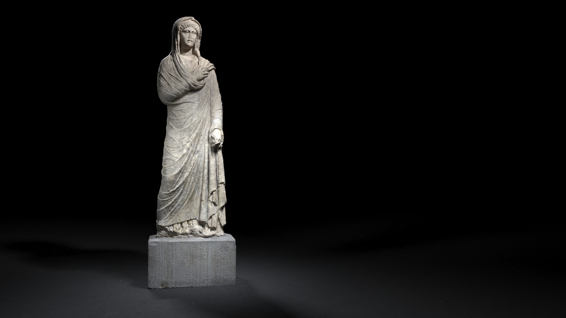 A full-length marble statue of a robed woman from ancient Rome, possibly a goddess or noblewoman, standing in a frontal pose with her head covered, illuminated against a dark background.