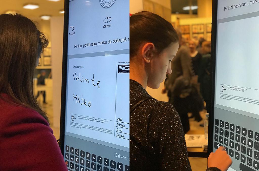 Visitors at the National Library in Belgrade interact with a multi-touch screen displaying a variety of postcards.
