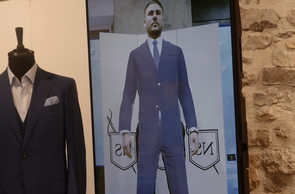 A Virtual Mirror display shows a man virtually wearing a tailored suit.