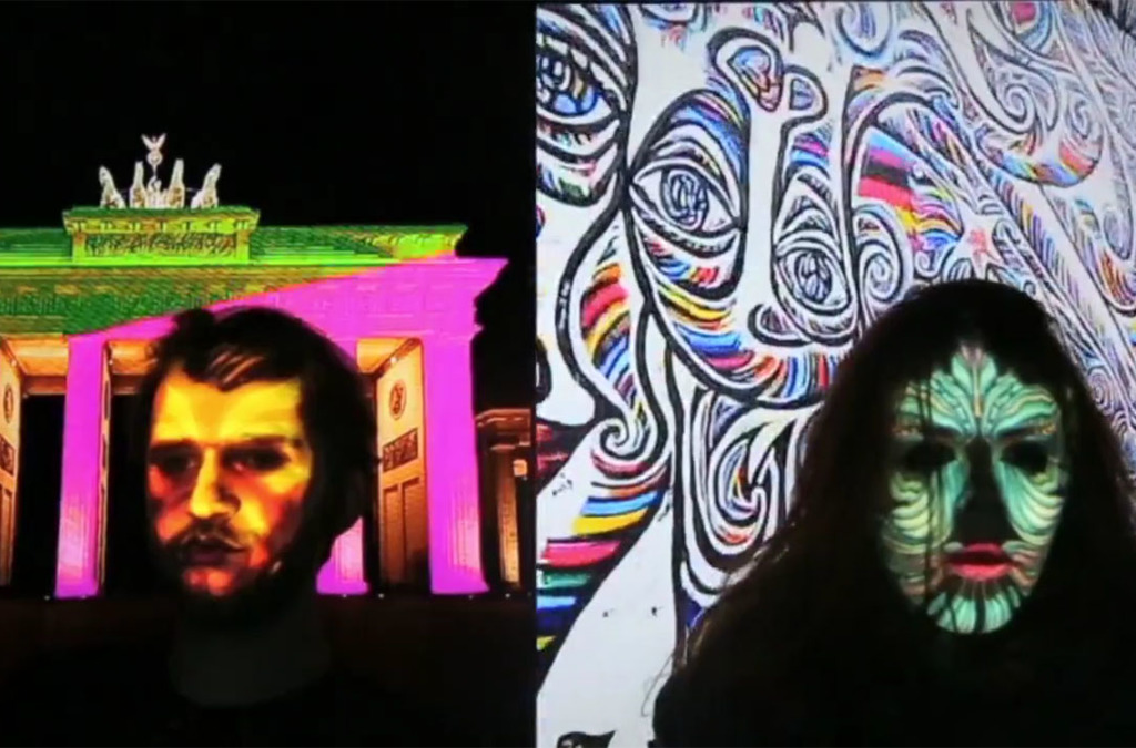 Participants in a face mapping event are shown with projections of the Brandenburg Gate and swirling black and white patterns on their faces.