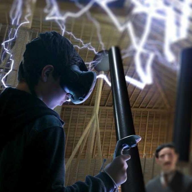 A person wearing a VR headset stands before a vivid display of electrical effects, holding a controller, immersed in a virtual reality experience.