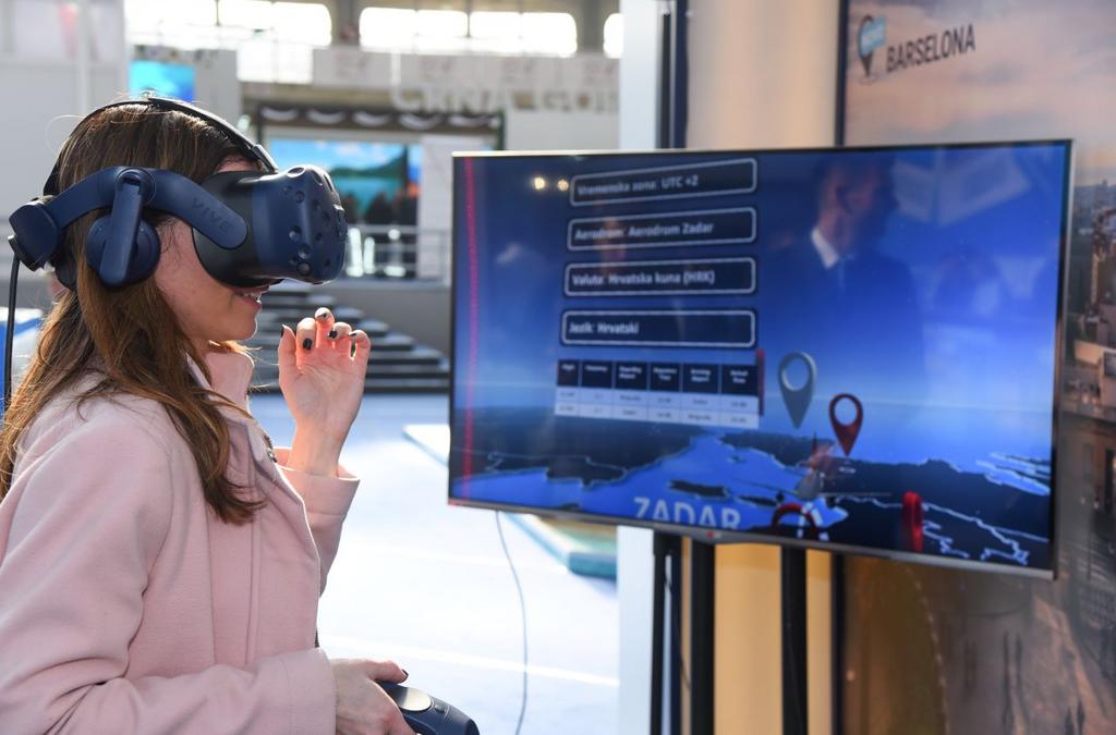 A visitor experiences a virtual reality tour of Air Serbia's aircraft.