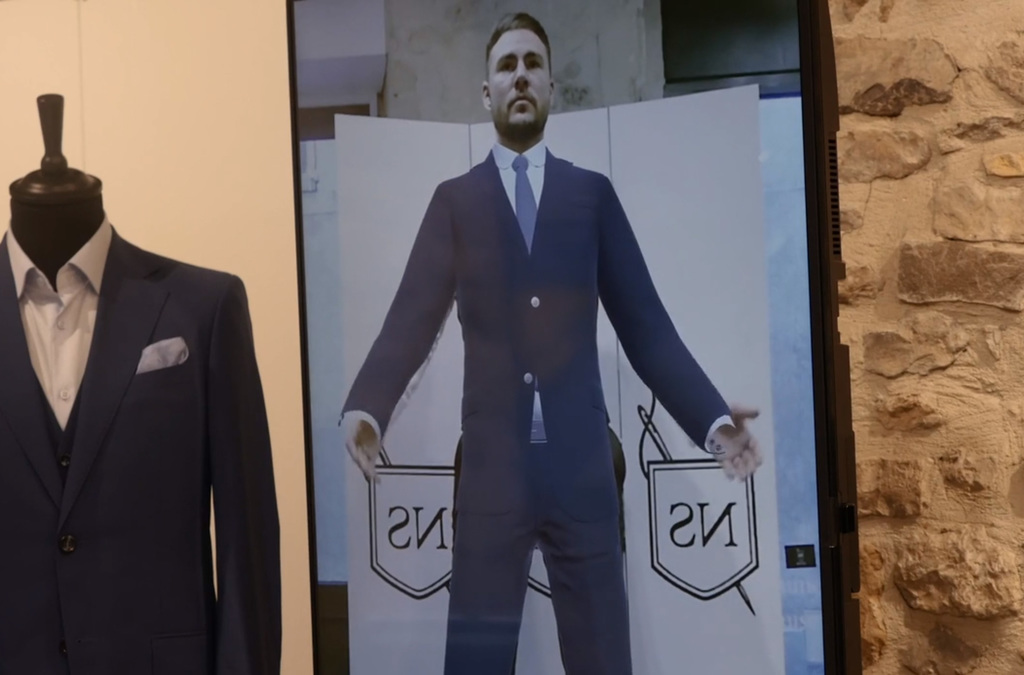 A Virtual Mirror display shows a man virtually wearing a tailored suit.