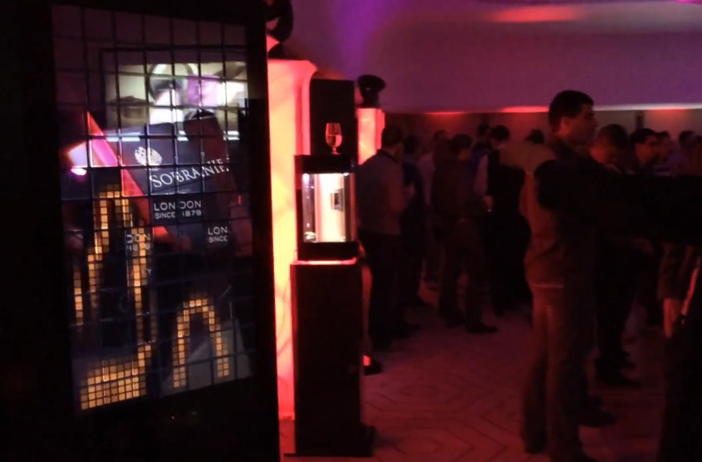 Attendees interact with a SOBRANIE advertising totem that displays dynamic content in response to their movements.