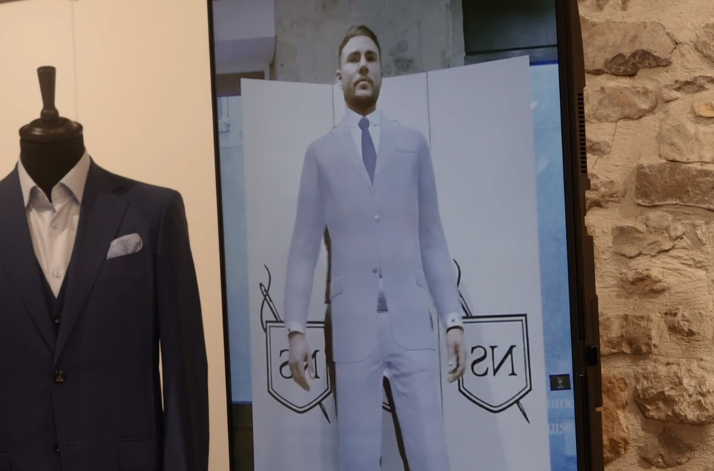 A Virtual Mirror display shows a man virtually wearing a tailored suit.