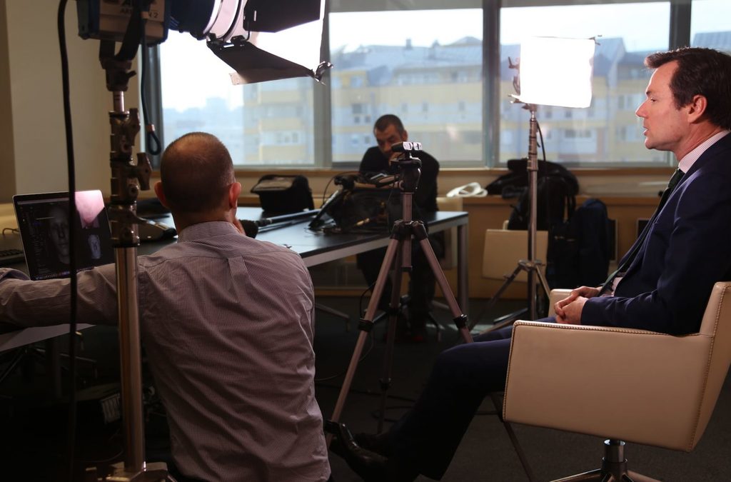 A professional video production set up with a man being interviewed, capturing the GM's message, representing Societe Generale Serbia's commitment to digitalization and innovation.