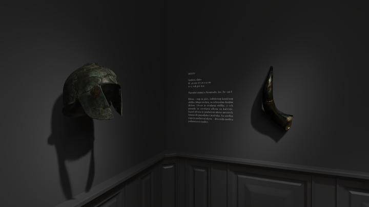 Close-up of a green ancient Greek Corinthian helmet mounted on a dark wall, beside a fragment of a bronze sheath, both under dramatic spotlights creating stark shadows.