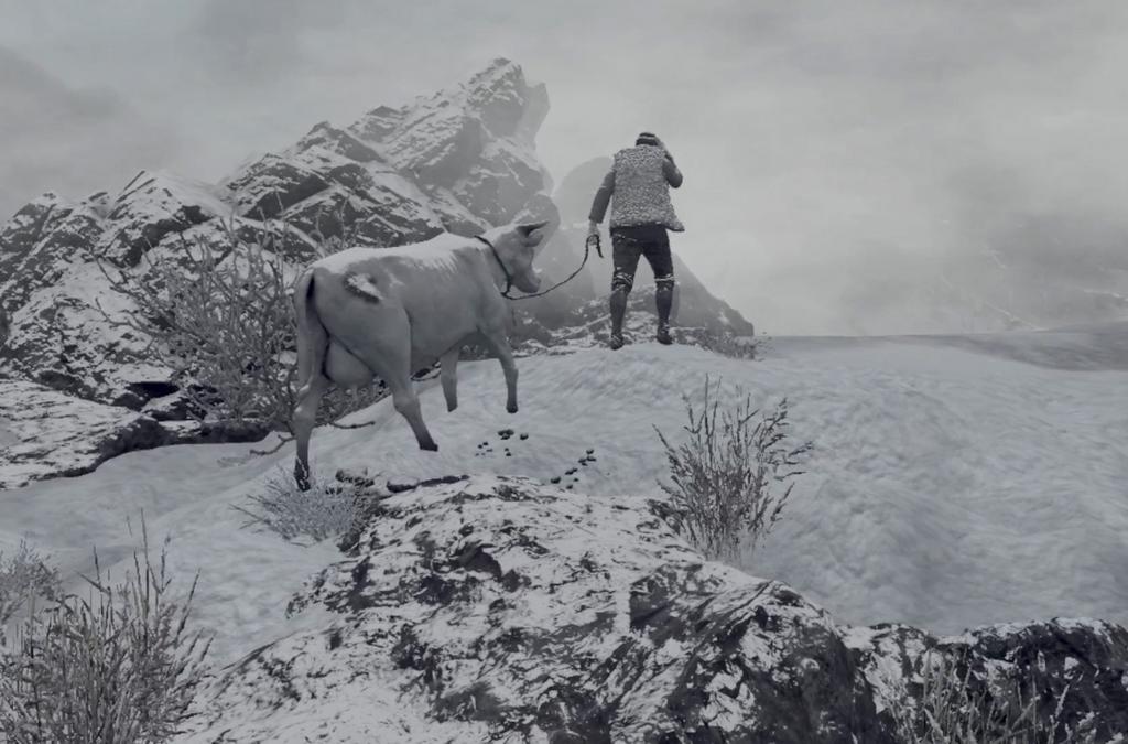 A man leading a cow through a snowy mountain landscape.
