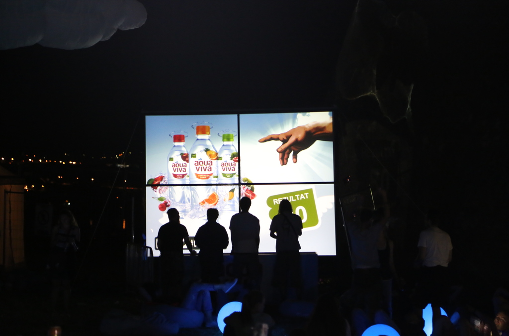 Visitors at the EXIT festival interact with a 4x3 meter multi-touch screen, playing a ball throwing game during an Aqua Viva activation.
