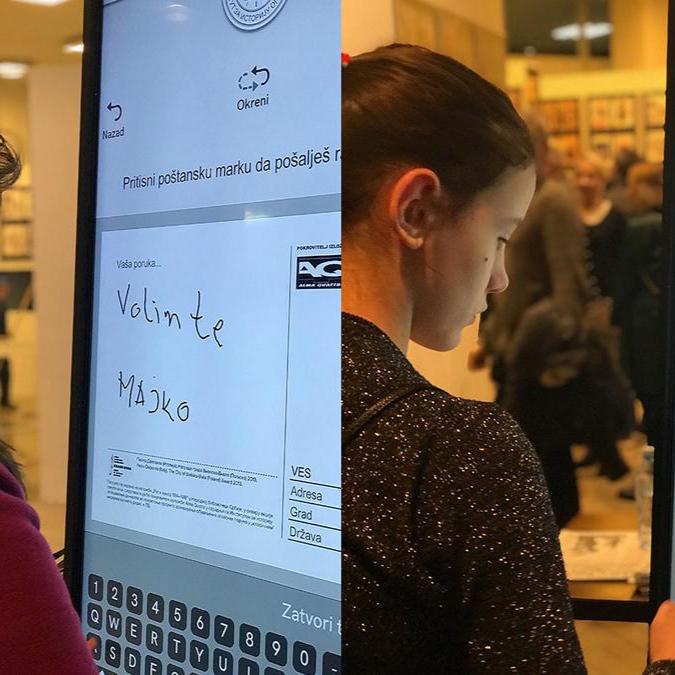 Visitors at the National Library in Belgrade interact with a multi-touch screen displaying a variety of postcards.