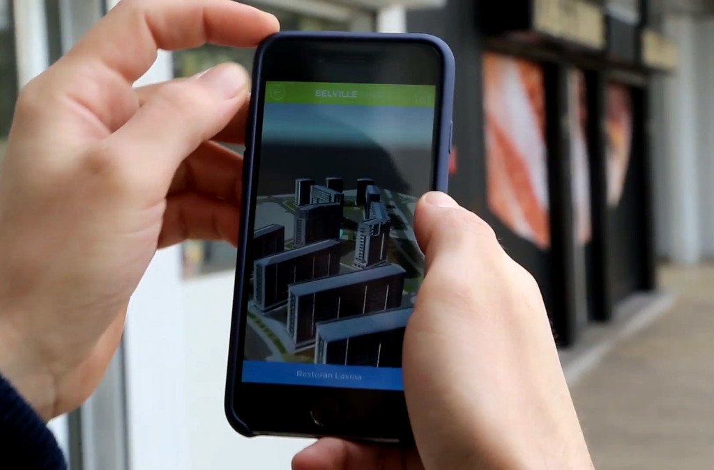 User holding a smartphone with the Belville Smart App opened.