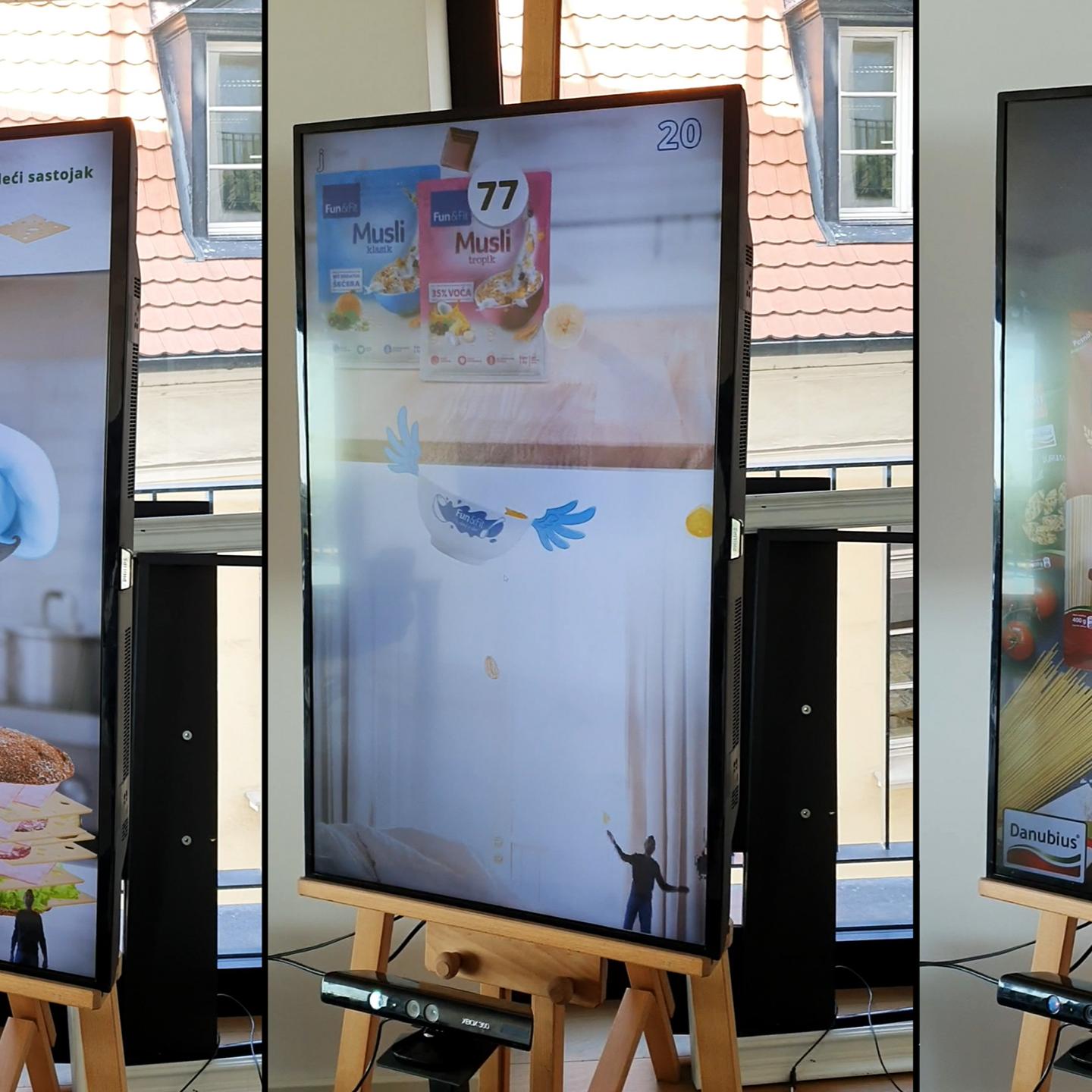A trio of interactive displays from the Delta KINECT Experiences, featuring motion-controlled games set up in a shopping mall. 