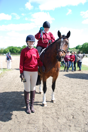 Alma Headinger from Chichester RDA riding Bella is pleased with her rosette