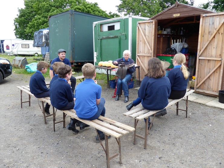 Carol Rycroft demonstrates parts of the saddle to a group at Court Meadow