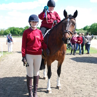 Alma Headinger from Chichester RDA riding Bella is pleased with her rosette