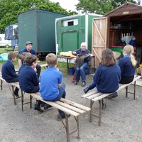Carol Rycroft demonstrates parts of the saddle to a group at Court Meadow