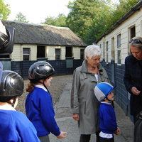 Dame Judi Dench talks to RDA children from Queen Elizabeth II School, Horsham and her...