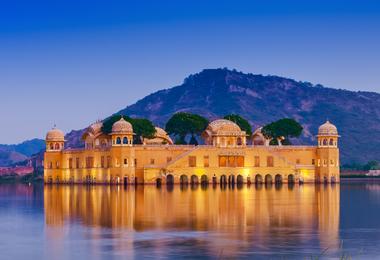 The blue waters of the lake contrast with the sand-coloured Lake Palace in Udaipur