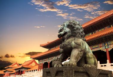 A statue of a lion guards the entrance to the Forbidden City in Beijing