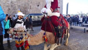 Santa-Claus-visits-Jerusalem-on-camelback