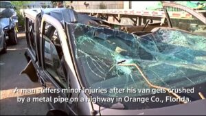Van-crushed-by-metal-pipe-on-Florida-highway