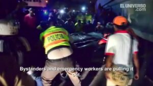 Passersby pull out car smashed by Ecuador bridge