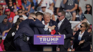 Trump rushed off stage after shots ring out at rally