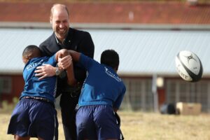 Britain’s Prince William plays rugby with South African students