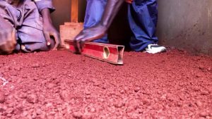 In Uganda a low-cost alternative to dirt floors gains ground